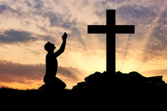 silhouette-man-praying-concept-religion-cross-sunset-60374726